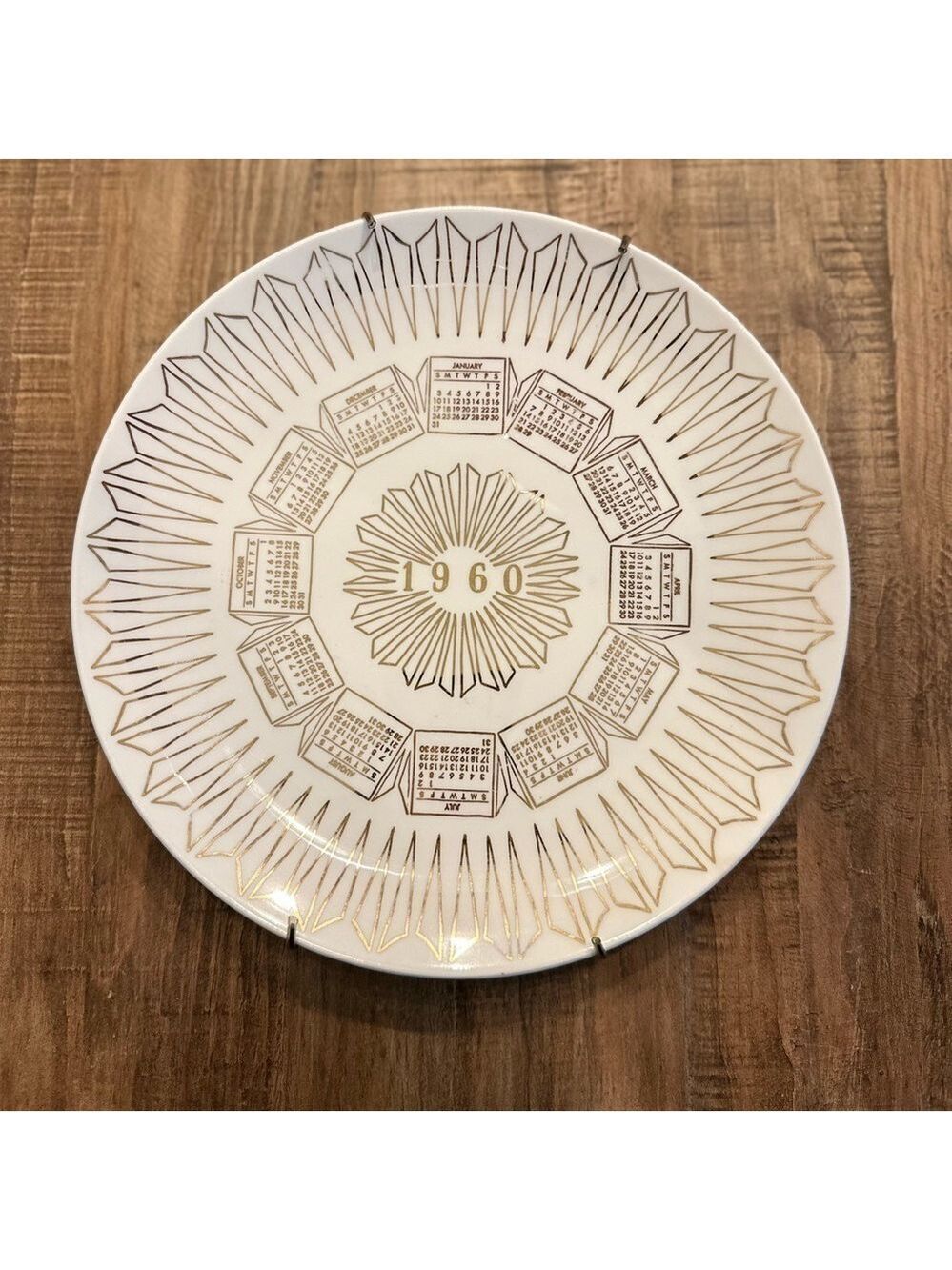 Vintage 1960 Calendar plate. Excellent shape. Wall hanger included. White + Gold